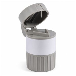 Gray travel bottle with a flip-top cap and ribbed gray base, wrapped with a white label in the middle